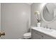 Elegant powder room featuring modern vanity, decorative mirror and tiled backsplash at 155 N Fayette Dr, Fayetteville, GA 30214