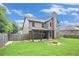 Spacious backyard with a covered patio and fire pit, perfect for outdoor gatherings at 229 Traditions Drive Southeast Dr, Loganville, GA 30052