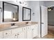 Elegant bathroom with double vanity, granite countertop, and framed mirrors at 229 Traditions Drive Southeast Dr, Loganville, GA 30052