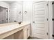 Spacious bathroom with double doors, a large mirror, vanity and cabinets at 229 Traditions Drive Southeast Dr, Loganville, GA 30052