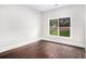 Bedroom featuring wood floors and a window overlooking a green yard at 229 Traditions Drive Southeast Dr, Loganville, GA 30052