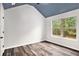 Unique bedroom with a blue ceiling, wood floors, and a window with a treed view at 229 Traditions Drive Southeast Dr, Loganville, GA 30052