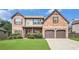 Beautiful two-story brick home with well-manicured lawn and attached two-car garage at 229 Traditions Drive Southeast Dr, Loganville, GA 30052