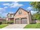 Attractive two-story home featuring a brick and siding exterior, complemented by a two-car garage at 229 Traditions Drive Southeast Dr, Loganville, GA 30052