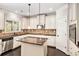 Well-lit kitchen with stainless steel appliances and a center island with granite countertops at 229 Traditions Drive Southeast Dr, Loganville, GA 30052