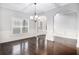 Bright living room with hardwood floors, large windows, and elegant trim, perfect for entertaining at 229 Traditions Drive Southeast Dr, Loganville, GA 30052
