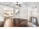Spacious living room featuring hardwood floors, a ceiling fan, and seamless access to the kitchen and staircase at 229 Traditions Drive Southeast Dr, Loganville, GA 30052