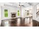 Cozy living room with a stone fireplace, hardwood floors, and coffered ceilings at 229 Traditions Drive Southeast Dr, Loganville, GA 30052