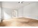 Large bedroom with neutral walls, carpeted floors, and a view through arched doorway at 229 Traditions Drive Southeast Dr, Loganville, GA 30052