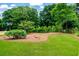 Large backyard with mature trees and a grassy area at 4049 Northlake Creek Cv, Tucker, GA 30084