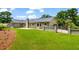Well-maintained backyard with a lush lawn and a gated driveway at 4049 Northlake Creek Cv, Tucker, GA 30084