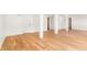 Unfinished basement with hardwood flooring, white walls, and support beams at 4049 Northlake Creek Cv, Tucker, GA 30084