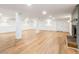 Spacious basement with hardwood floors, white columns, and a charming fireplace at 4049 Northlake Creek Cv, Tucker, GA 30084