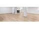 Basement featuring white walls and hardwood floors with a kitchen in the background at 4049 Northlake Creek Cv, Tucker, GA 30084