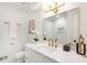 Elegant bathroom with a large mirror, white cabinetry and gold hardware at 4049 Northlake Creek Cv, Tucker, GA 30084