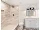 Modern bathroom featuring tile surround shower, updated vanity, and geometric tile flooring at 4049 Northlake Creek Cv, Tucker, GA 30084