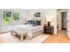 Bedroom featuring a window, hardwood floors, white walls, and neutral-toned furnishings at 4049 Northlake Creek Cv, Tucker, GA 30084