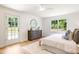 Bright bedroom with light hardwood floors, white walls, and a door leading to the outside at 4049 Northlake Creek Cv, Tucker, GA 30084