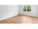 Bedroom with a large window showing a green view and hardwood floors at 4049 Northlake Creek Cv, Tucker, GA 30084