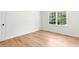 Bright bedroom featuring hardwood floors and double-hung windows at 4049 Northlake Creek Cv, Tucker, GA 30084