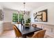 Elegant dining room featuring modern lighting, large windows, and an inviting atmosphere for gatherings at 4049 Northlake Creek Cv, Tucker, GA 30084