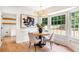 Bright and airy dining room with large windows, elegant lighting, and stylish furniture at 4049 Northlake Creek Cv, Tucker, GA 30084
