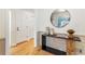 Bright foyer featuring hardwood floors, decorative mirror, and a stylish console table creates a welcoming entrance at 4049 Northlake Creek Cv, Tucker, GA 30084