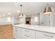 Basement kitchen with island, pendant lights, and a view into the expansive recreation space at 4049 Northlake Creek Cv, Tucker, GA 30084