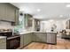 Spacious kitchen with stainless steel appliances, white countertops, and stylish gray-green cabinetry at 4049 Northlake Creek Cv, Tucker, GA 30084
