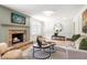 Cozy living room featuring a brick fireplace, comfortable seating, and elegant decor at 4049 Northlake Creek Cv, Tucker, GA 30084