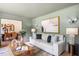 Bright living room with stylish decor, hardwood floors, and seamless connection to the adjacent dining area at 4049 Northlake Creek Cv, Tucker, GA 30084