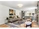 Open-concept living room seamlessly connects to the kitchen with stylish decor and plenty of natural light at 4049 Northlake Creek Cv, Tucker, GA 30084