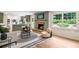 Bright living room with fireplace, hardwood floors, modern furnishings, and a view of the lush outdoors at 4049 Northlake Creek Cv, Tucker, GA 30084