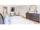 Bright main bedroom with elegant furniture, a large dresser, and a door to the patio at 4049 Northlake Creek Cv, Tucker, GA 30084