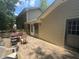 Exterior view of a wooden back deck with seating area and back entrance to the home at 4147 Scofield Pl, Stonecrest, GA 30083
