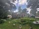 Spacious backyard with mature trees and plants, and an elevated wooden deck at 4147 Scofield Pl, Stonecrest, GA 30083