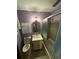 Cozy bathroom with a vanity, toilet, mirror, and a shower with sliding glass doors at 4147 Scofield Pl, Stonecrest, GA 30083