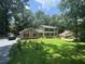 Charming home with a lush lawn, brick accents, and inviting front porch perfect for relaxing in a serene setting at 4147 Scofield Pl, Stonecrest, GA 30083