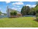 Expansive backyard featuring a large, well-maintained lawn, wooden pergola, and mature trees at 7325 Brookwood Way, Cumming, GA 30041