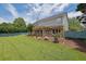 Expansive backyard featuring a pergola covered patio and lush green lawn at 7325 Brookwood Way, Cumming, GA 30041