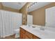 Bathroom featuring double sinks, a large mirror, and a shower with a curtain at 7325 Brookwood Way, Cumming, GA 30041