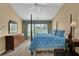 Bedroom featuring a four-poster bed, vaulted ceiling, ceiling fan, and a large window with natural light at 7325 Brookwood Way, Cumming, GA 30041