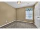 Bedroom with a large window, neutral carpeting, and a white closet door at 7325 Brookwood Way, Cumming, GA 30041
