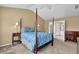 Bedroom featuring a four-poster bed, vaulted ceiling, ceiling fan, and an ensuite bathroom at 7325 Brookwood Way, Cumming, GA 30041