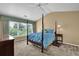 Bedroom with a vaulted ceiling, ceiling fan, four-poster bed, and a large window at 7325 Brookwood Way, Cumming, GA 30041