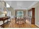 Formal dining room with large windows, hardwood floors, and traditional furnishings at 7325 Brookwood Way, Cumming, GA 30041