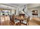Open-concept dining area with hardwood floors, staircase, and bright natural light at 7325 Brookwood Way, Cumming, GA 30041