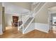 Bright foyer with staircase, hardwood floors, and elegant trim, leading to dining area at 7325 Brookwood Way, Cumming, GA 30041