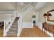 Welcoming foyer with staircase, hardwood floors, and views into the dining area at 7325 Brookwood Way, Cumming, GA 30041