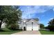 Traditional two-story home with a well-maintained lawn, blue shutters, and a two-car garage at 7325 Brookwood Way, Cumming, GA 30041